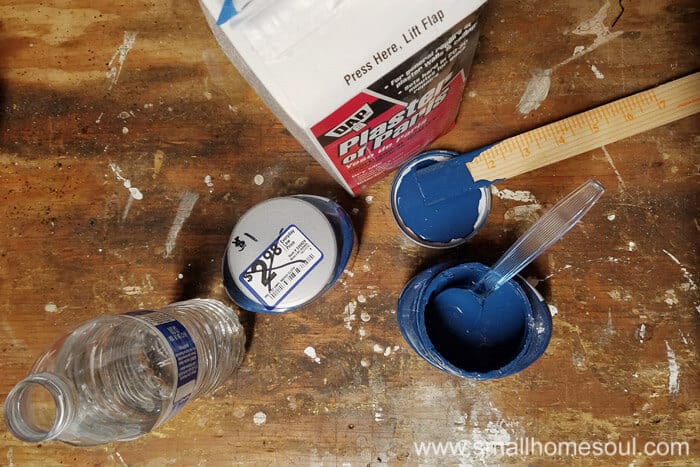 Mixing up chalky paint for the folding stool seat.