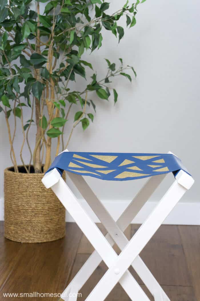 The folding stool is all glammed up with gold accents.