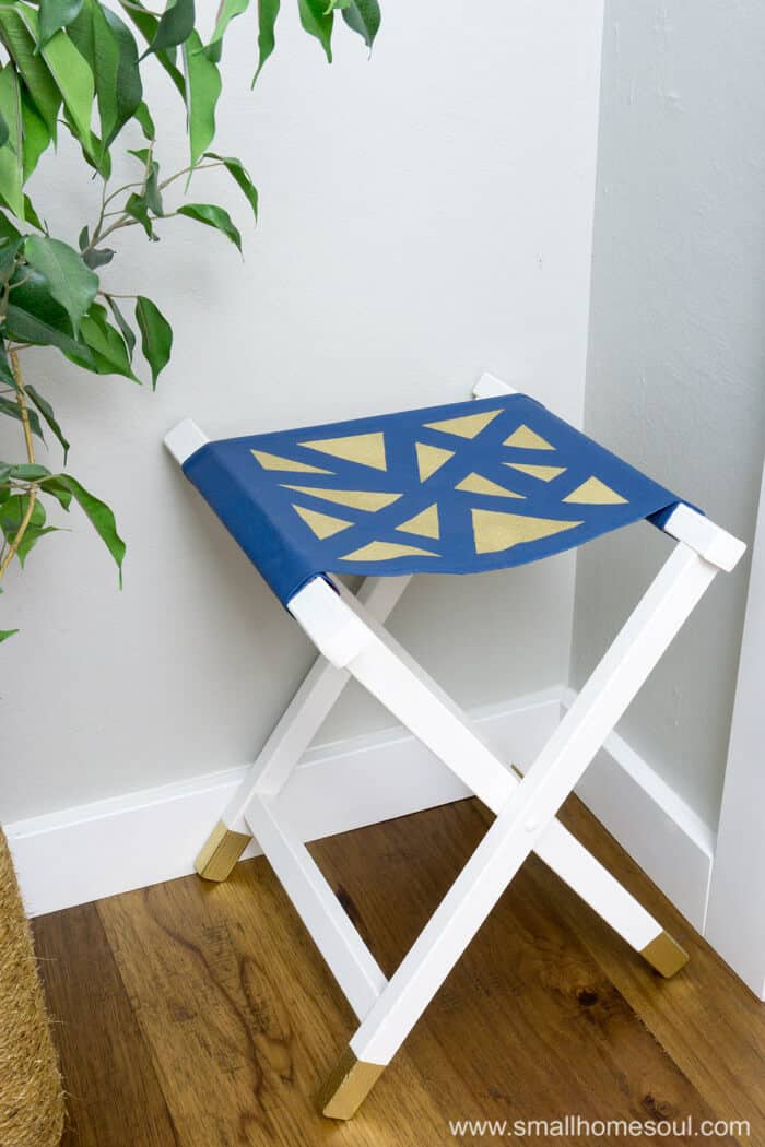 Gold accents on the folding stool seat and feet.