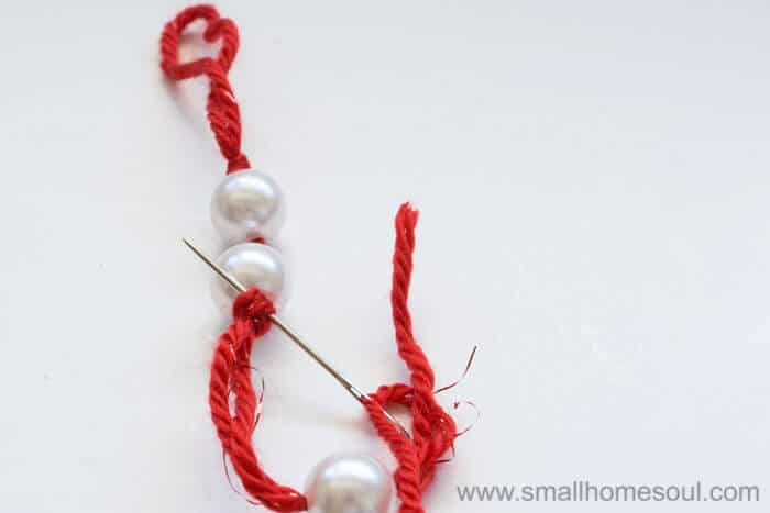 Knots around beads on Christmas Tassel Ornament.