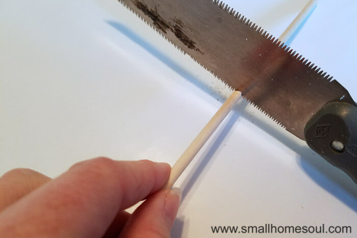 Cutting the dowel for grateful wall hanging.