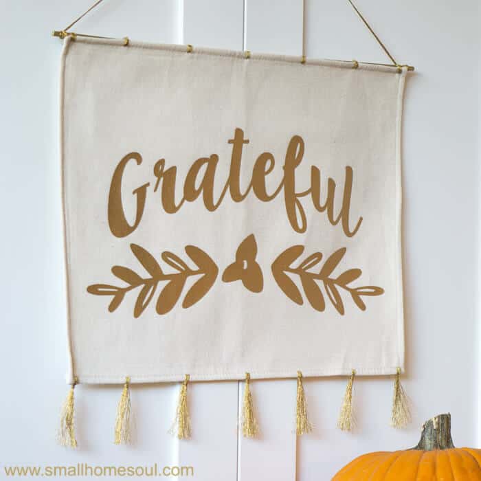 Square grateful wall hanging with pumpkin.