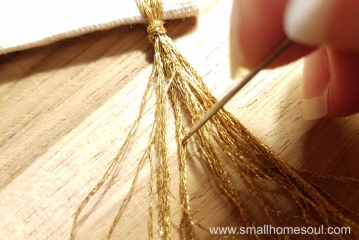 Separating floss threads on the grateful wall hanging.