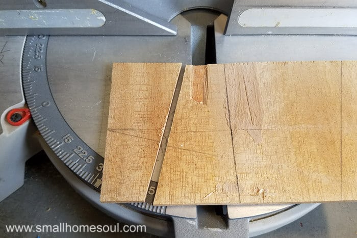 Legs of phone charging stand on the saw.