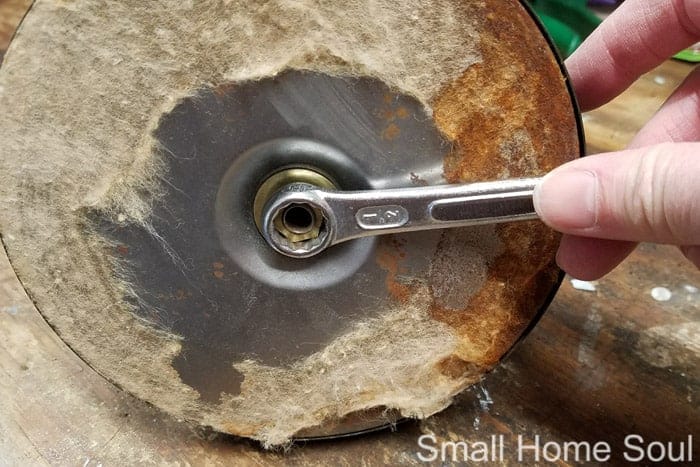 Start the desk lamp makeover by removing the bottom nut.