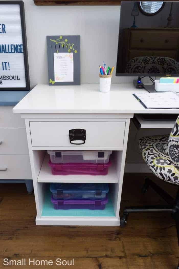 Colorful storage in desk after office makeover.