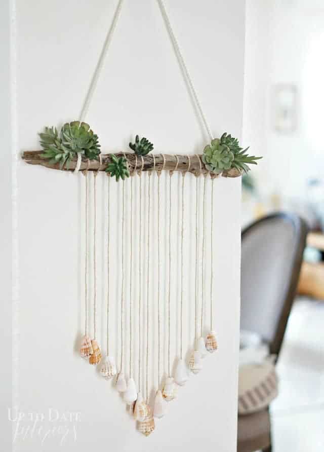 Seashells in creative coastal decor door hanging.