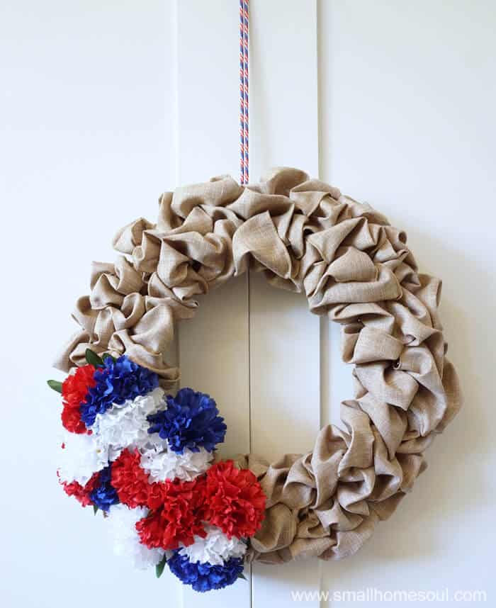 A shoestring hangs the July 4th Wreath from the door for 4th of July.