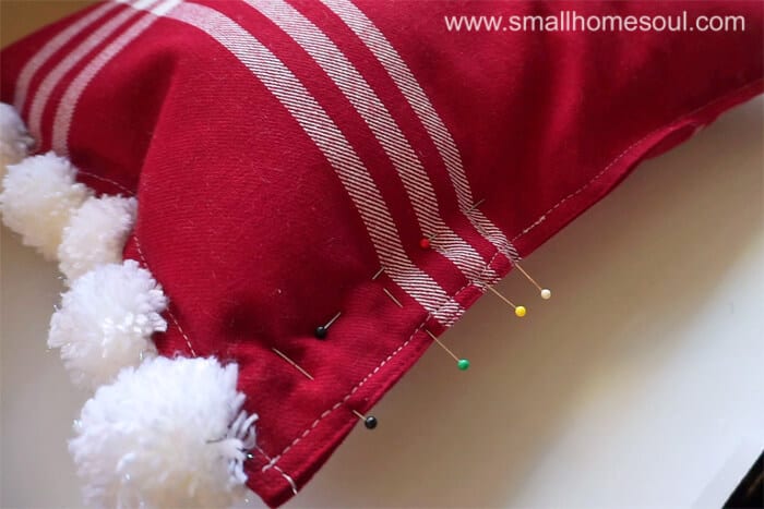 Pin & sew edge of Christmas Pom Pom Pillow