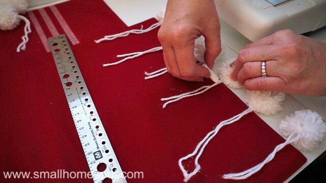 Use chalk on Christmas Pom Pom Pillow for placement.