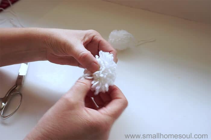 Trimming other side of perfect pom pom.