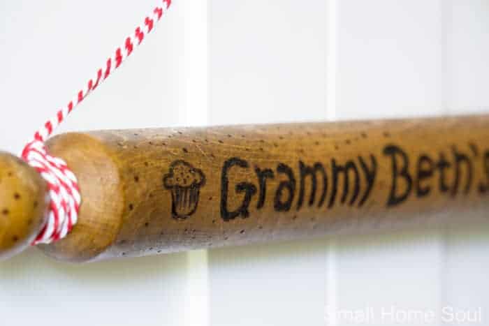 Grammy and a muffin on the wooden rolling pin.